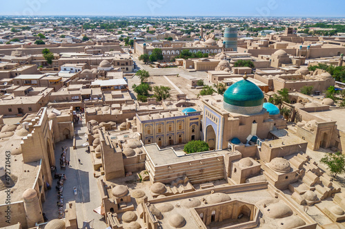 Panorama of Ichan-Kala, center of Khiva, Uzbekistan. City has changed little over centuries. Mausoleum of Pahlavan Mahmud on foreground, in distance Kalta Minor tower and other historical buildings
