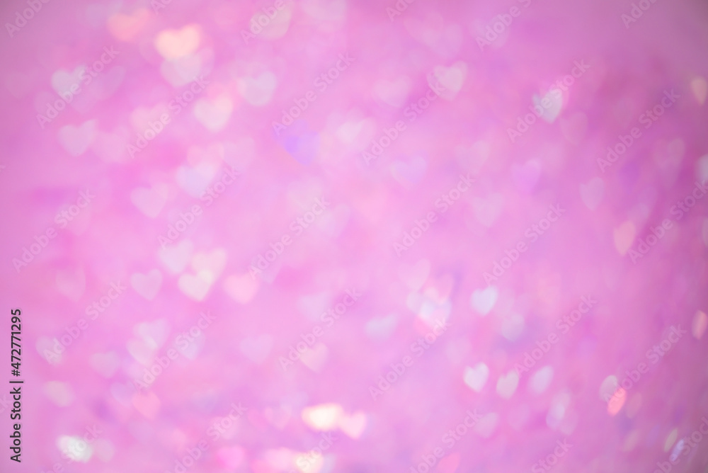 Natural pink bokeh of lights in the form of a heart, blurred out of focus background. Abstract beautiful backdrop for text or advertising. Postcard with love in light gentle colors