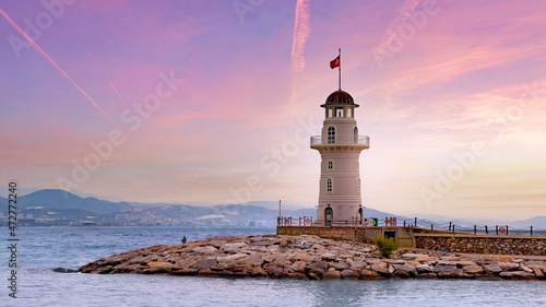 View of the lighthouse at a scenic beautiful pink sunset. Wallpaper, background