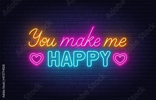 You Make Me Happy neon sign on brick wall background.