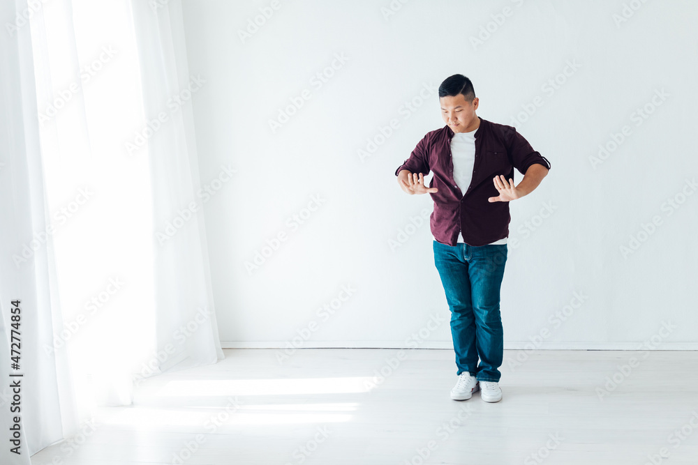 Asian man dancing to music alone at home Asian man dancing to music alone at home