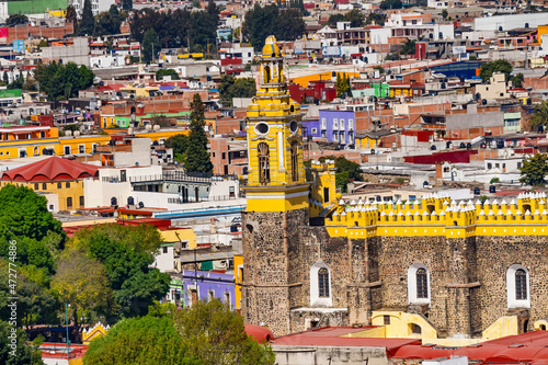 Colorful church, restaurants and shops, Cholula, Puebla, Mexico. Church built 1500's photo