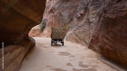 Horse carriage riding through the Siq Canyon to Al-khazneh (The Treasury), Petra, Jordan photo
