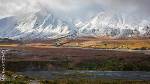 USA, Alaska. Fall colors in Denali National Park with clouds shrouding Mt. Denali, formerly known as Mt. McKinley.