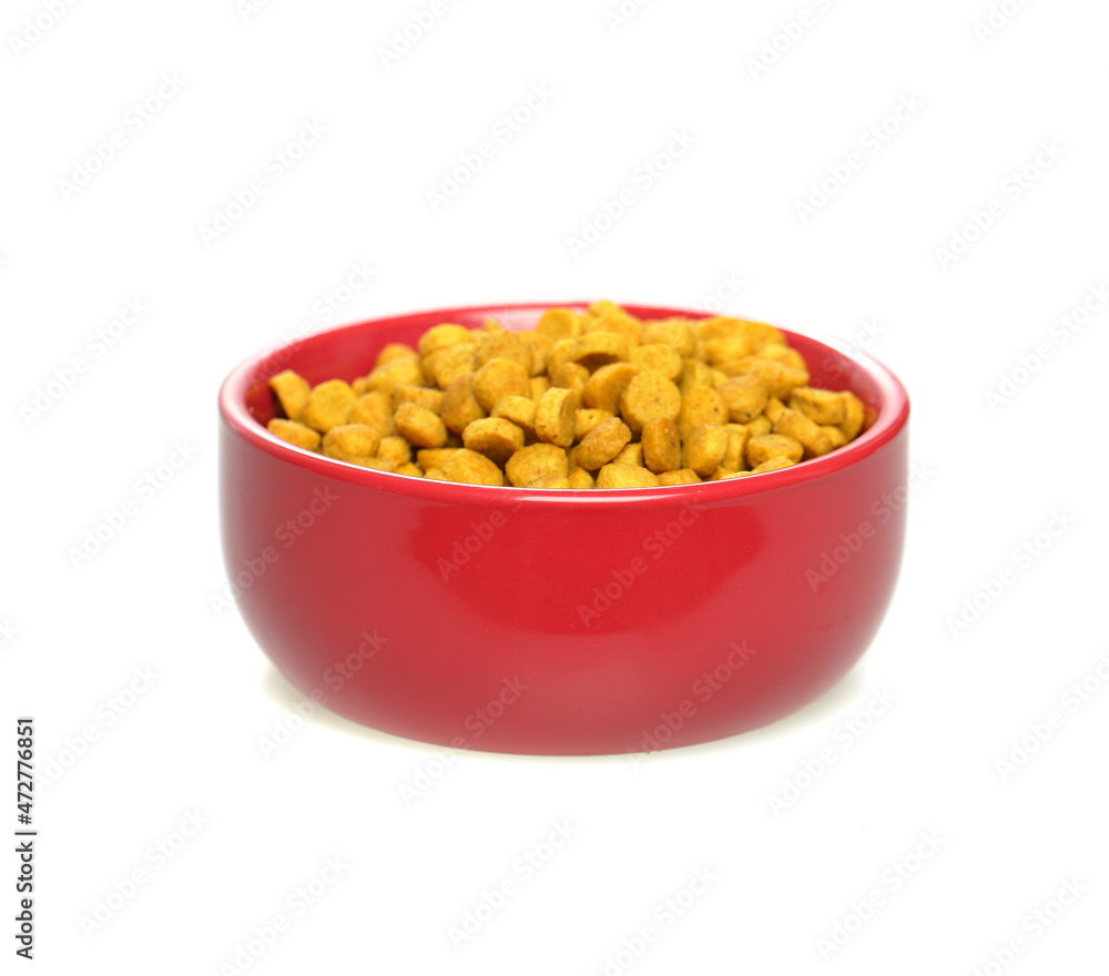 Dry food for dogs and cats in red bowl on white background Dry food for dogs and cats in red bowl on white background