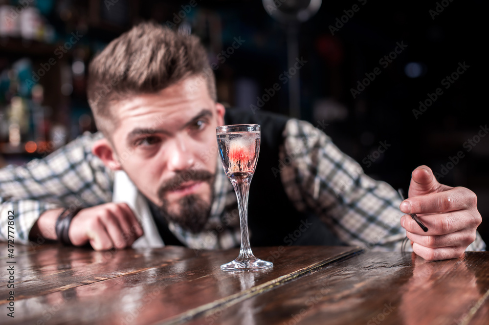 Barman mixes a cocktail in the taproom