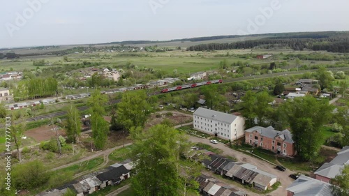 Aerial view of an electric train passing by the village (Strizhi, Kirov region, Russia) photo