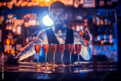 Girl barman makes a cocktail at the porterhouse photo