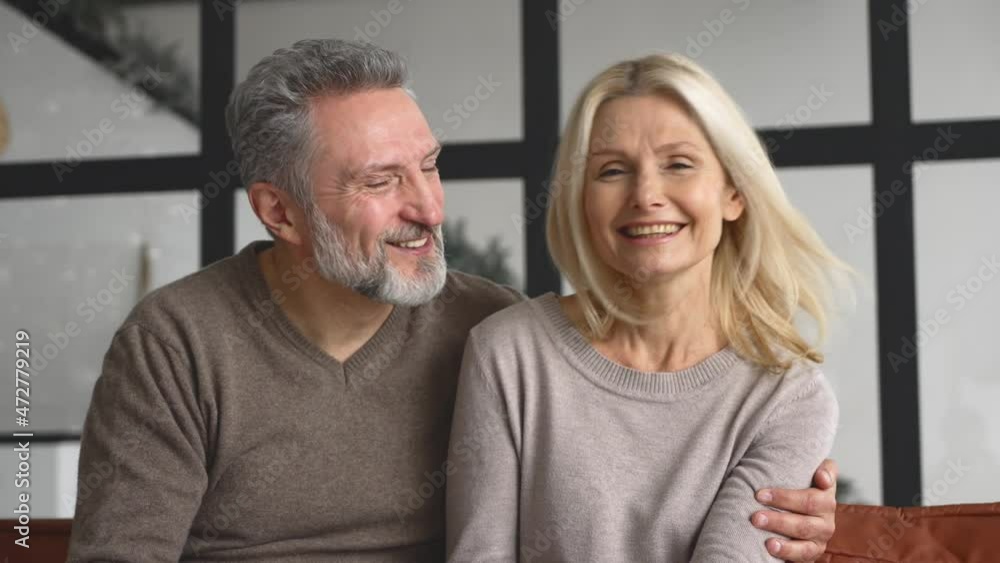 Video meeting with a happy middle-aged couple, cheerful spouses waving, looking and talking at the webcam. Virtual connection with mature parents, virtual conference, video call Video meeting with a happy middle-aged couple, cheerful spouses waving, looking and talking at the webcam. Virtual connection with mature parents, virtual conference, video call