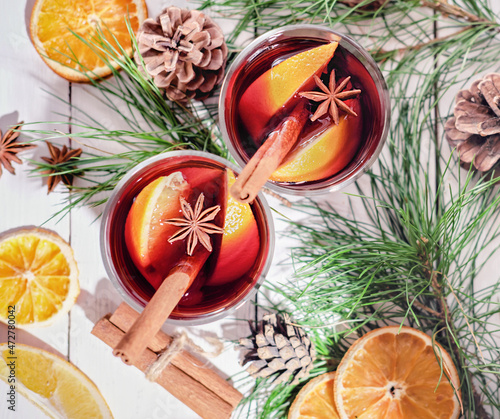 hot mulled wine glasses with oranges, cinnamon and anise stars. christmas flat lay, top view. holiday warm drinks, cozy winter time for family