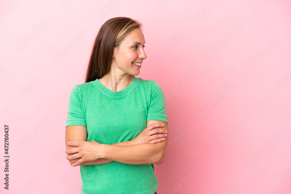 Young English woman isolated on pink background looking to the side and smiling Young English woman isolated on pink background looking to the side and smiling