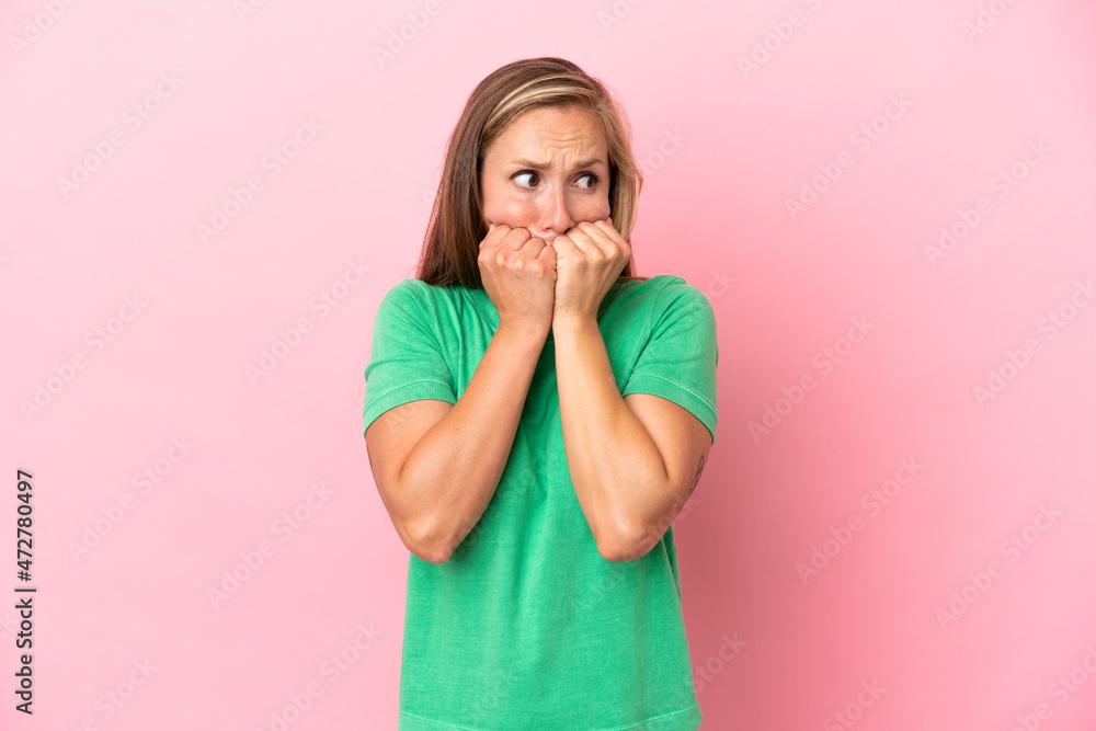 Young English woman isolated on pink background nervous and scared putting hands to mouth Young English woman isolated on pink background nervous and scared putting hands to mouth