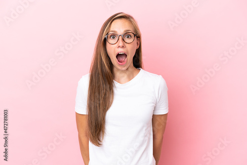 Young English woman isolated on pink background with surprise facial expression