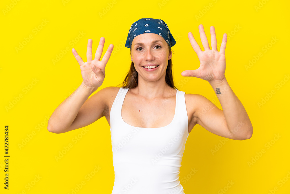 Young English woman isolated on yellow background counting nine with fingers Young English woman isolated on yellow background counting nine with fingers