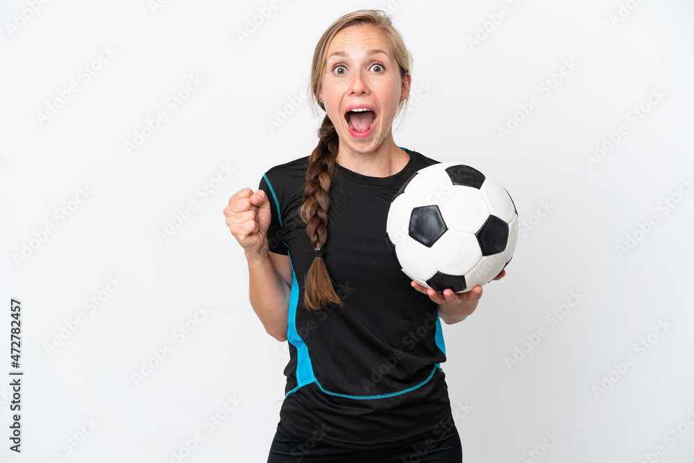 Young football player woman isolated on white background celebrating a victory in winner position