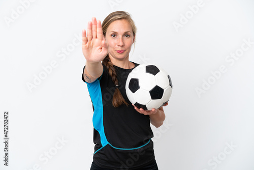 Young football player woman isolated on white background making stop gesture © luismolinero