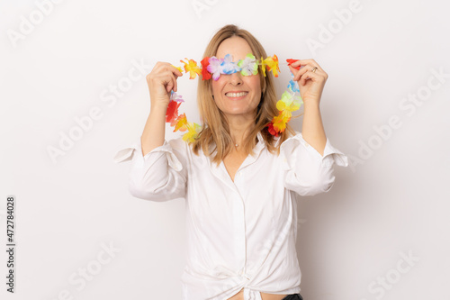 Young smiling woman covering eyes with hawaiian necklace isolated over white background.