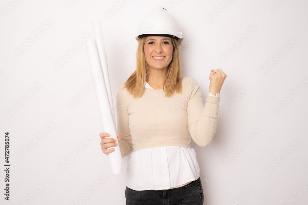 Young excited woman architect standing isolated over white background. Young excited woman architect standing isolated over white background.