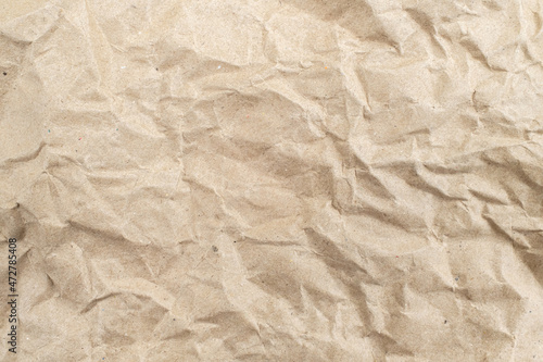 Recycled brown creased paper background from a paper packing. Crumpled brown paper texture concept