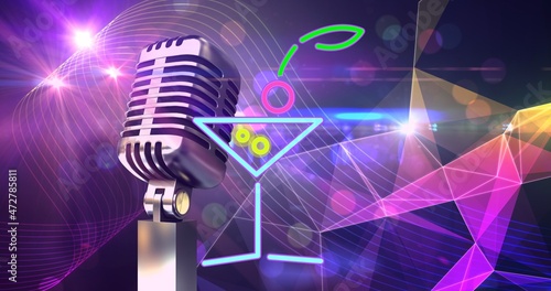 Composition of retro microphone and cocktail drink against illuminated abstract background