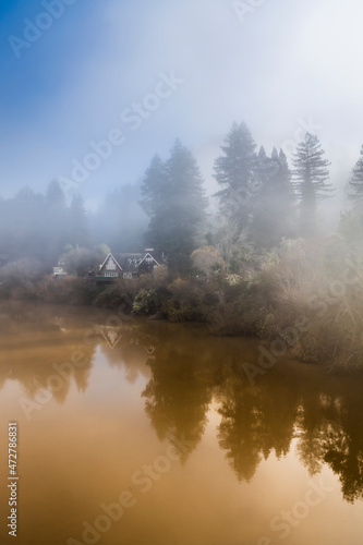 The fog clearing from the Russian River as the sun rises. © Danita Delimont