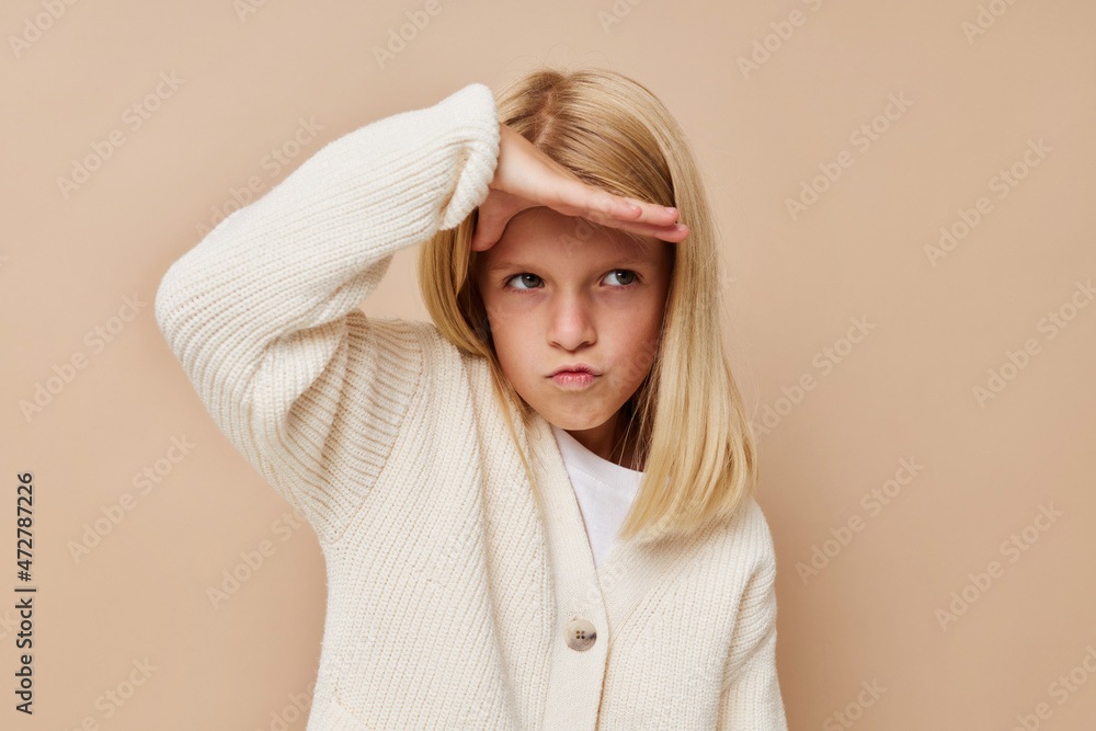 happy cute girl fashionable baby clothes on a beige background happy cute girl fashionable baby clothes on a beige background