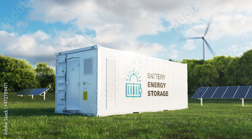 concept of a modern high-capacity battery energy storage system in a container located in the middle of a lush meadow with a forest in the background. 3d rendering photo