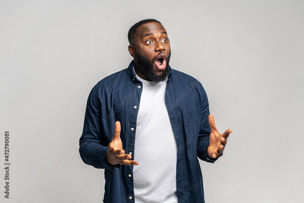 Shocked African American guy staring away with awe expression, amazed