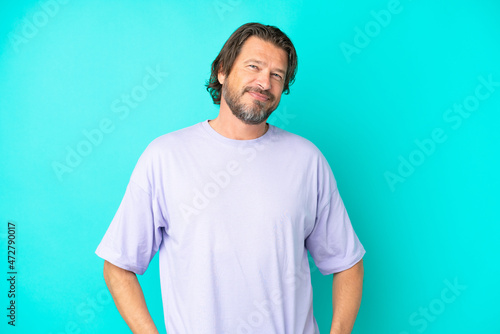 Senior dutch man isolated on blue background laughing