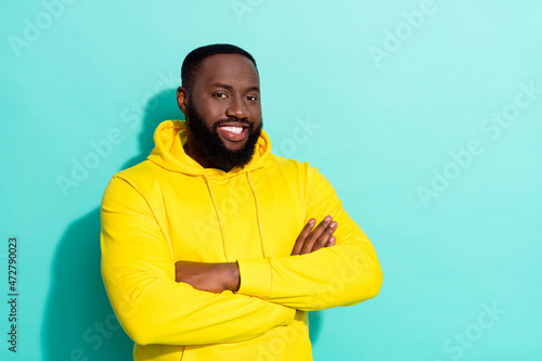 Photo of youngster positive cheerful guy stand empty space cross hands isolated over cyan color background © deagreez