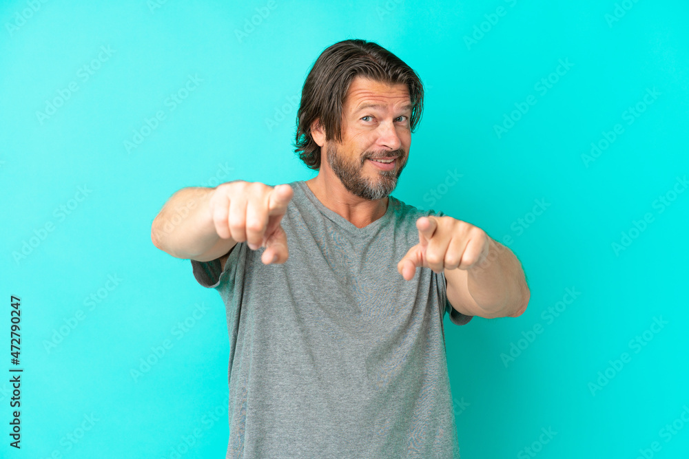 Senior dutch man isolated on blue background pointing front with happy expression Senior dutch man isolated on blue background pointing front with happy expression