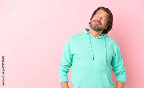 Senior dutch man isolated on pink background thinking an idea while looking up © luismolinero