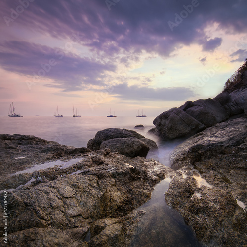Sea landscape with dramatic sky and boats on horizon