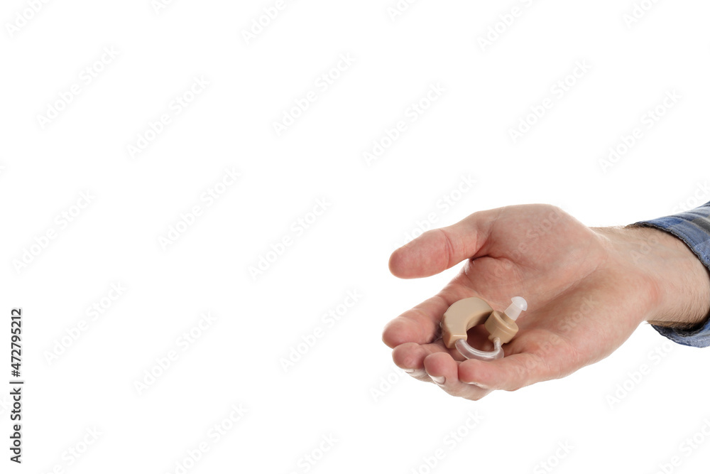 Hand holds hearing aid, isolated on white background Hand holds hearing aid, isolated on white background