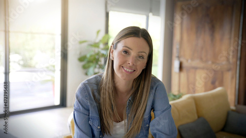 young brunette woman smiling casual in her house