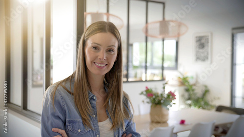 young brunette woman smiling casual in her house
