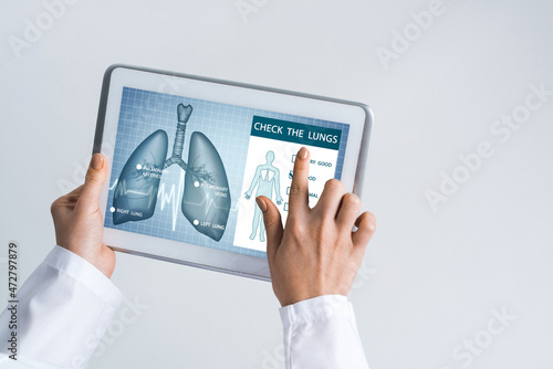 Close of female doctor hands working with tablet pc computer