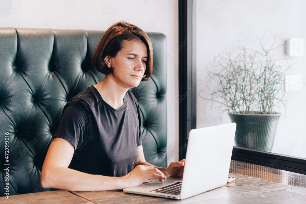 Businesswoman working at a café. woman using laptop, female hands typing, writing notes, studying languages, distance learning concept, checking email in morning, drink coffee Businesswoman working at a café. woman using laptop, female hands typing, writing notes, studying languages, distance learning concept, checking email in morning, drink coffee