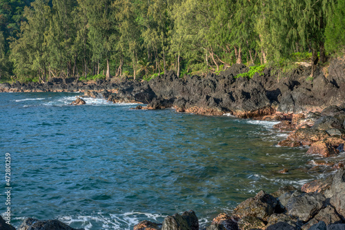 USA, Hawaii, Big Island of Hawaii. Laupahoehoe Point Beach Park, Volcanic rock, waves and forest in early morning. photo