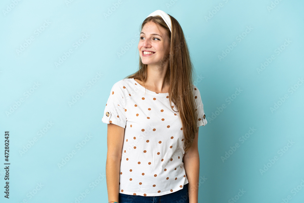Young caucasian woman over isolated background looking to the side and smiling Young caucasian woman over isolated background looking to the side and smiling