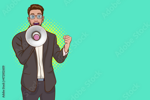 surprised young business man in glasses wearing grey suit screaming loud in megaphone