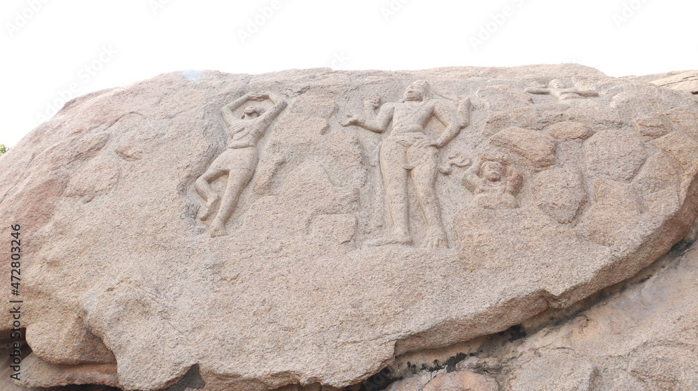 Arjuna's penance - ancient. Statues carved into the wall of the Mahabalipuram rock. The rock wall is located in the background. Arjuna's penance - ancient. Statues carved into the wall of the Mahabalipuram rock. The rock wall is located in the background.
