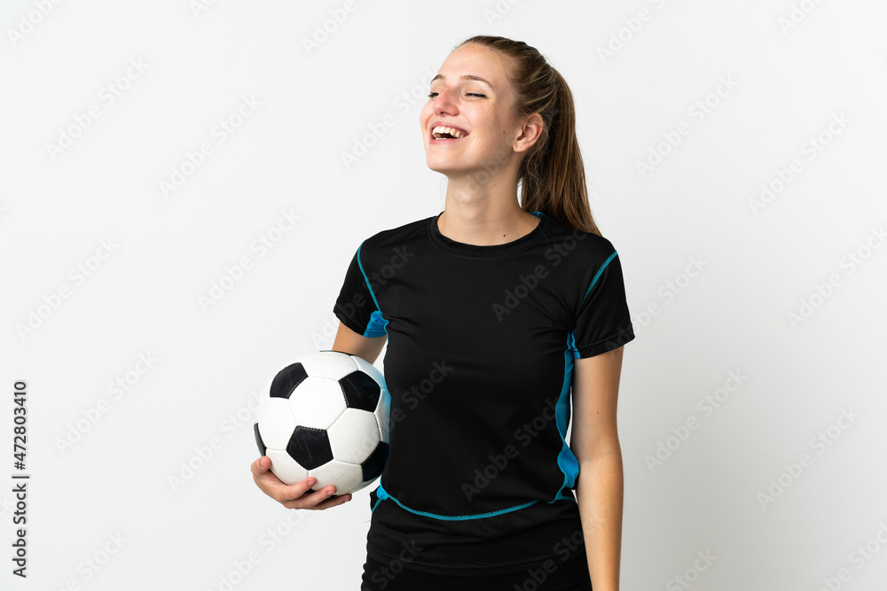 Young football player woman isolated on white background laughing in lateral position Young football player woman isolated on white background laughing in lateral position