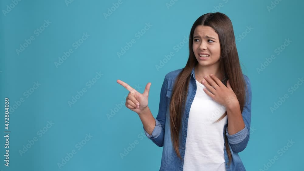 Kid lady point empty space not suggest choose isolated blue color background Kid lady point empty space not suggest choose isolated blue color background