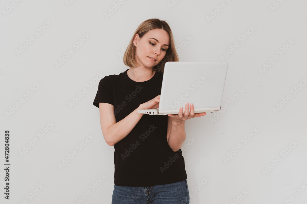 charming European woman in casual clothes holding laptop in her hands and video chating Isolated on white background charming European woman in casual clothes holding laptop in her hands and video chating Isolated on white background