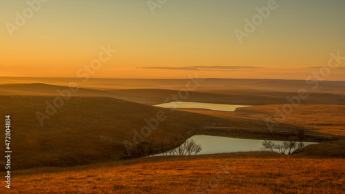 Sun just coming up over the Flint Hills with a light fog.