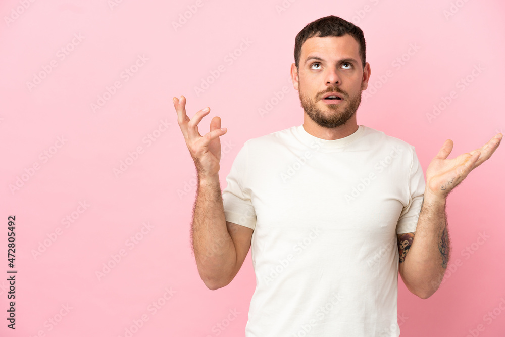 Young Brazilian man isolated on pink background stressed overwhelmed Young Brazilian man isolated on pink background stressed overwhelmed