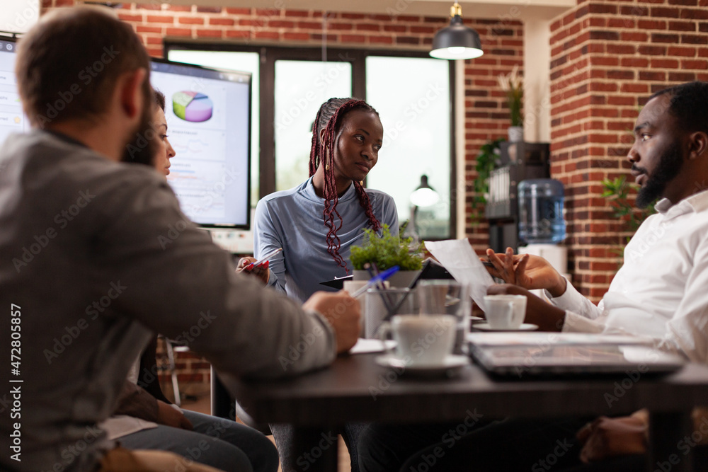 African american manager explaining marketing strategy working at company presentation brainstorming business ideas in startup office. Diverse businesspeople discussing financial partnership African american manager explaining marketing strategy working at company presentation brainstorming business ideas in startup office. Diverse businesspeople discussing financial partnership