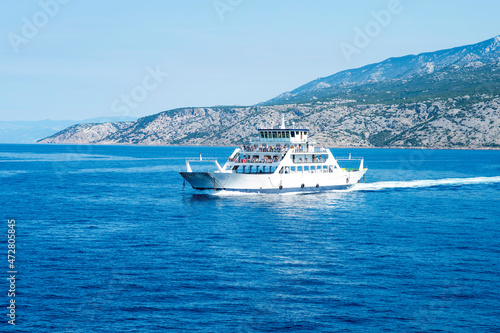 Fotografie Car ferry boat in Croatia linking the island Rab to mainland passing by on adriatic sea