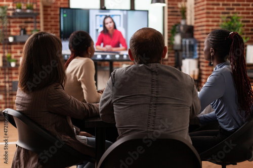 Executives managers people discussing project ideas with remote leader planning marketing presentation during online videocall meeting in startup company office. Business call conference on screen